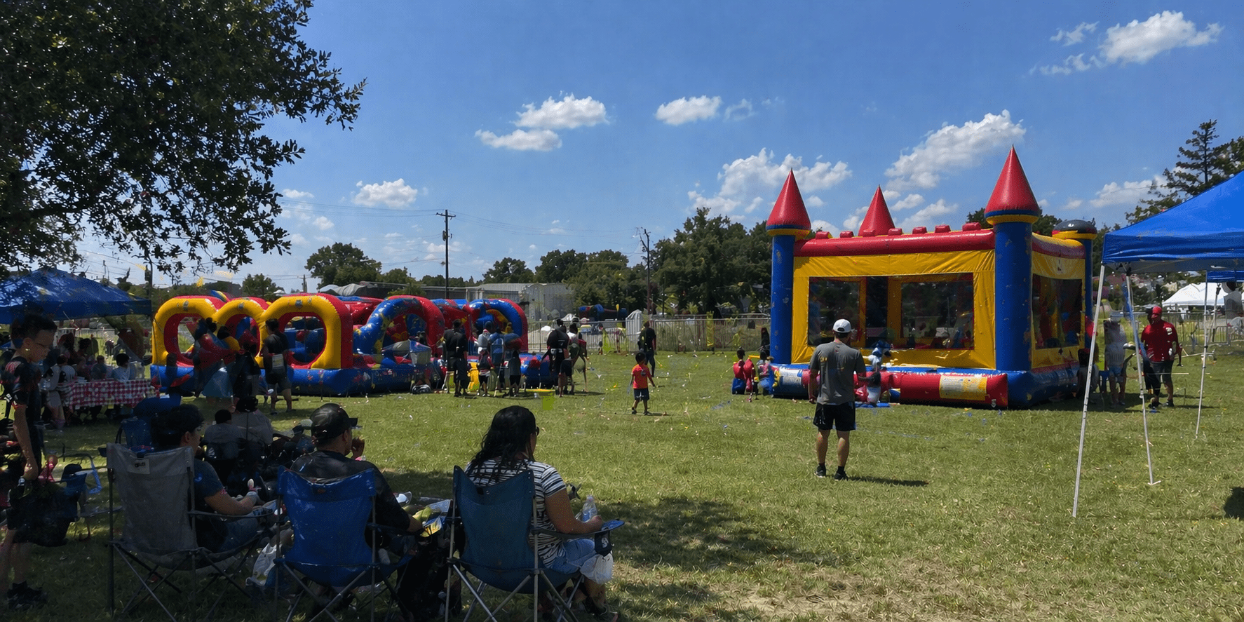 Community fair with inflatables and families