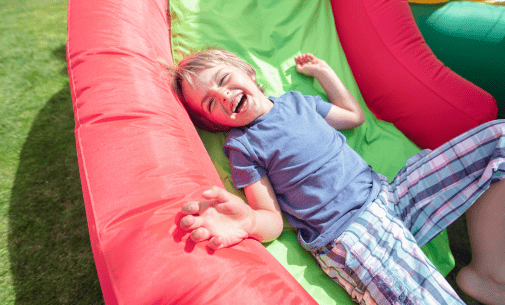 Happy child playing on a inflatable