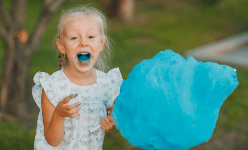 Little girl eating cotton candy